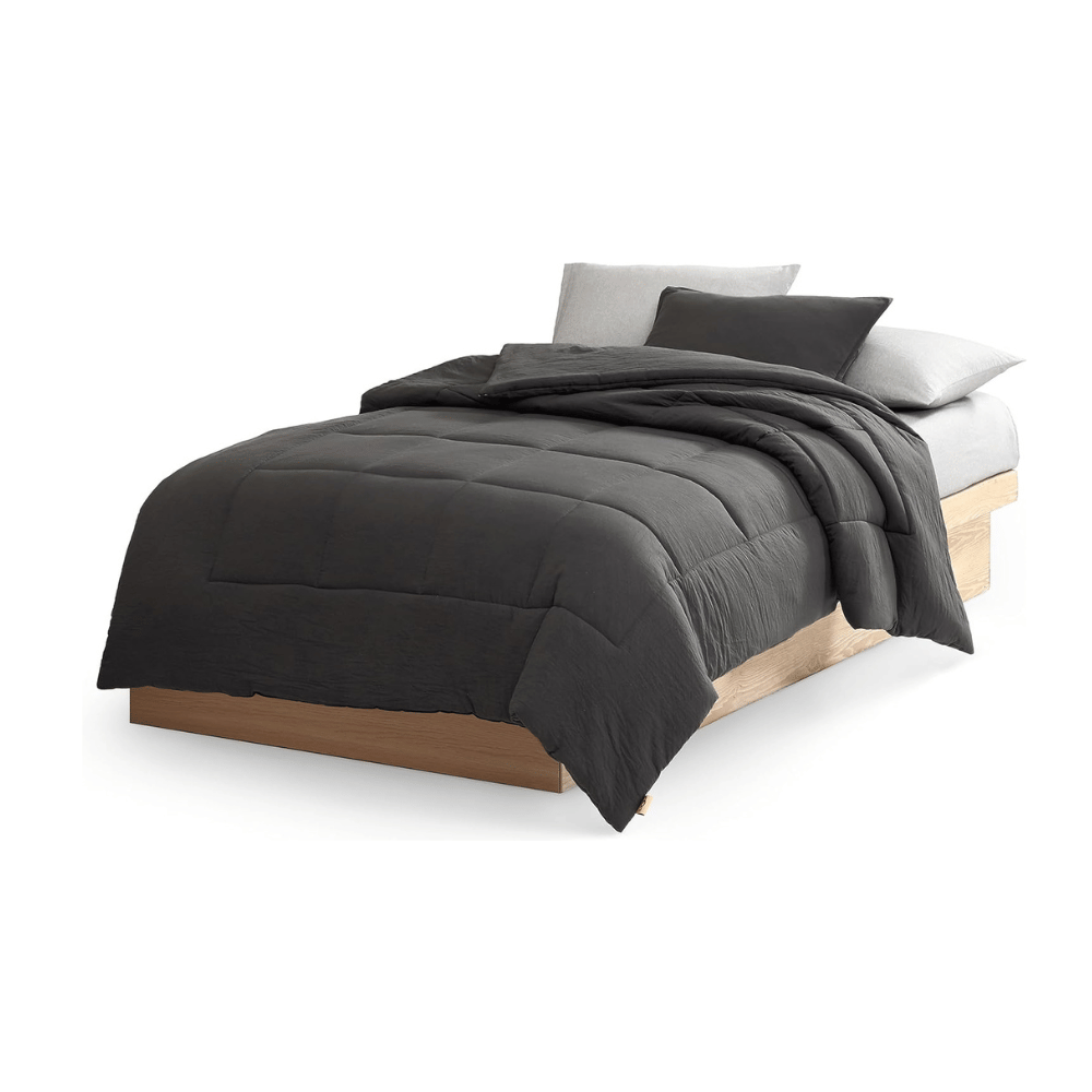 UGG Twin XL Down Alternative Comforter in charcoal gray on bed (Credit: UGG / Amazon)