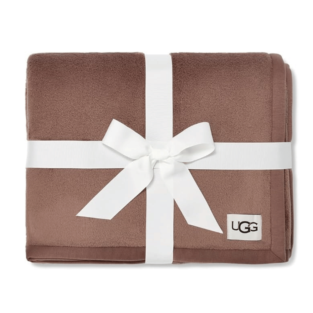 Folded brown UGG Ariana Twin XL Blanket tied with ribbon (Credit: UGG / Amazon)