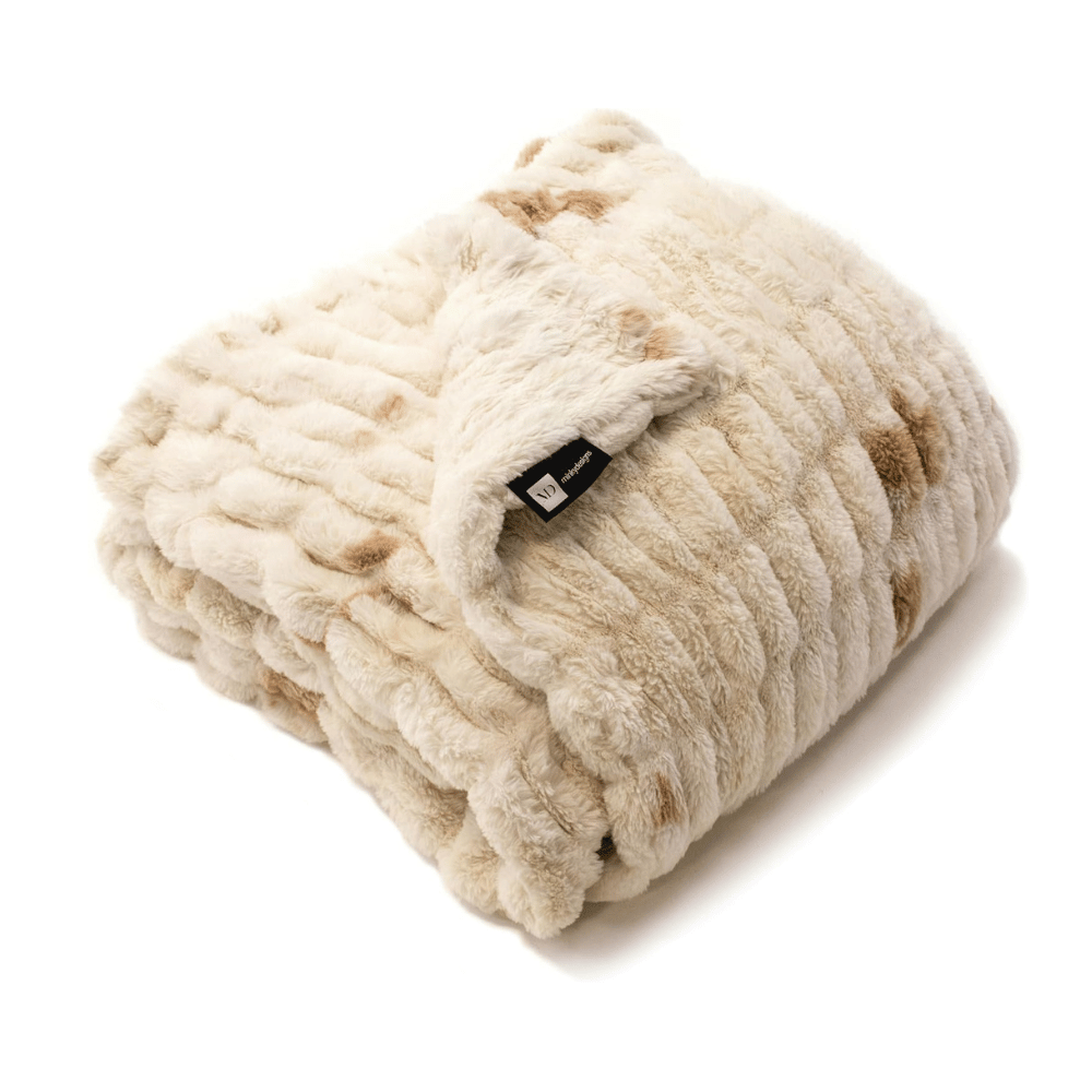 Folded Minky Designs Crème Brulee Faux Fur Blanket showing plush ribbed texture and cream-gold hue.
