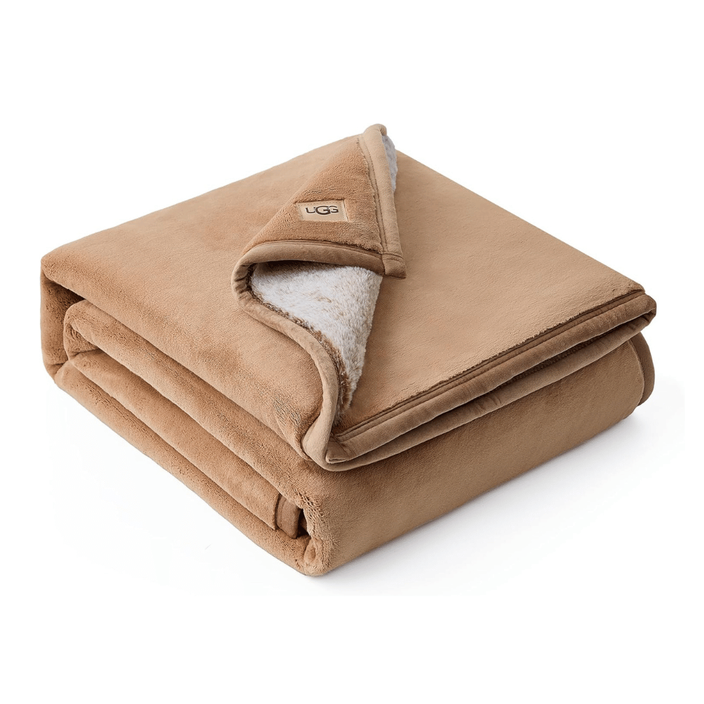 Folded UGG Salt Creek Throw Blanket showing dual faux fur and plush lining (Credit: MyRadiantSleep.com)