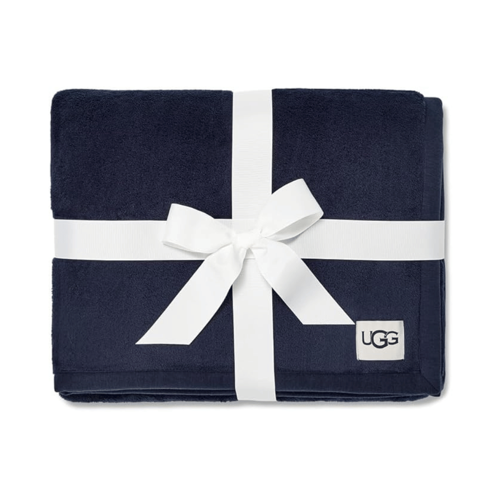 Folded navy blue UGG Duffield Throw II with gift ribbon (Credit: UGG / Amazon)