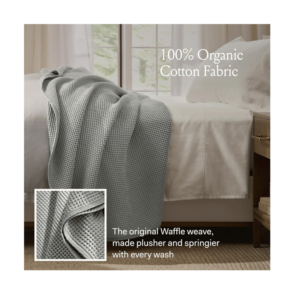 Gray Boll & Branch Waffle Bed Blanket draped over bed, showing detailed weave and soft cotton finish.