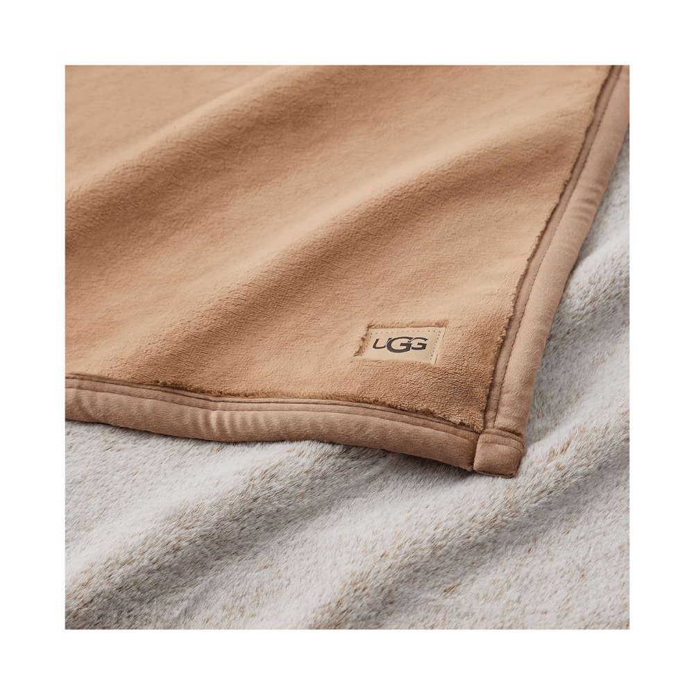 Close-up of UGG Salt Creek Throw Blanket label with plush faux fur texture (Credit: MyRadiantSleep.com)