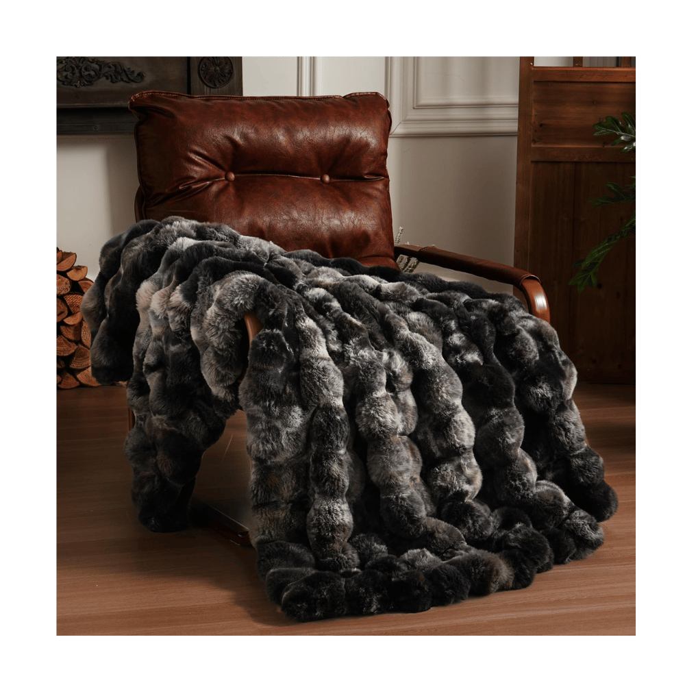 Dark gray BENWFE Fluffy Faux Fur Blanket draped over leather chair, showcasing thick faux fur layers and texture.