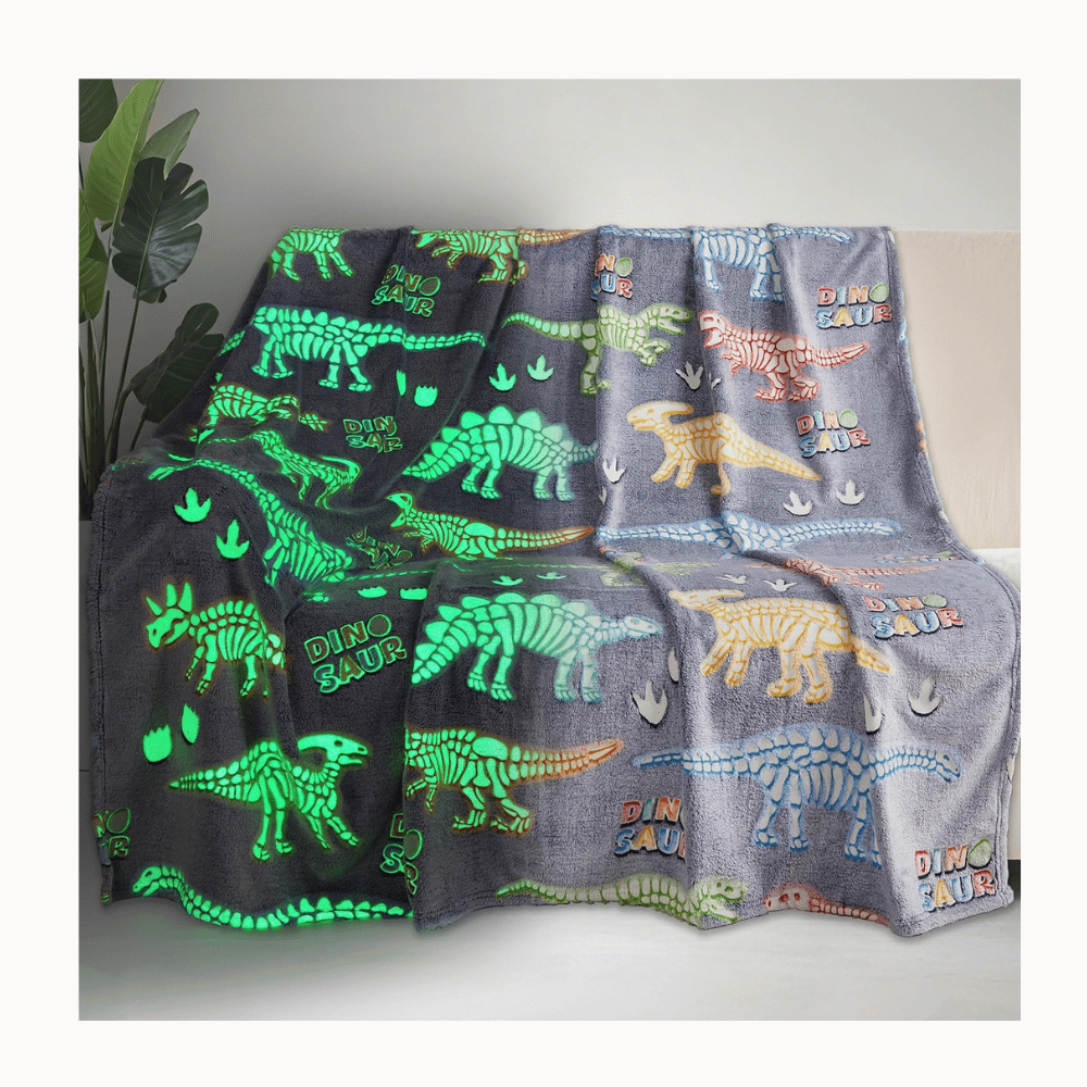 Glow blanket with dinosaur pattern.