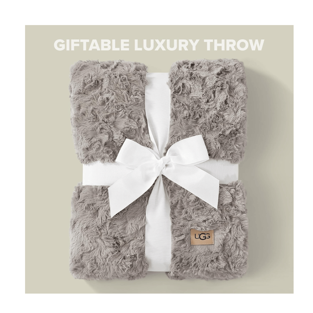 UGG Adalee Faux Fur Throw Blanket on chair showing plush textured design and cozy warmth (Credit: MyRadiantSleep.com)