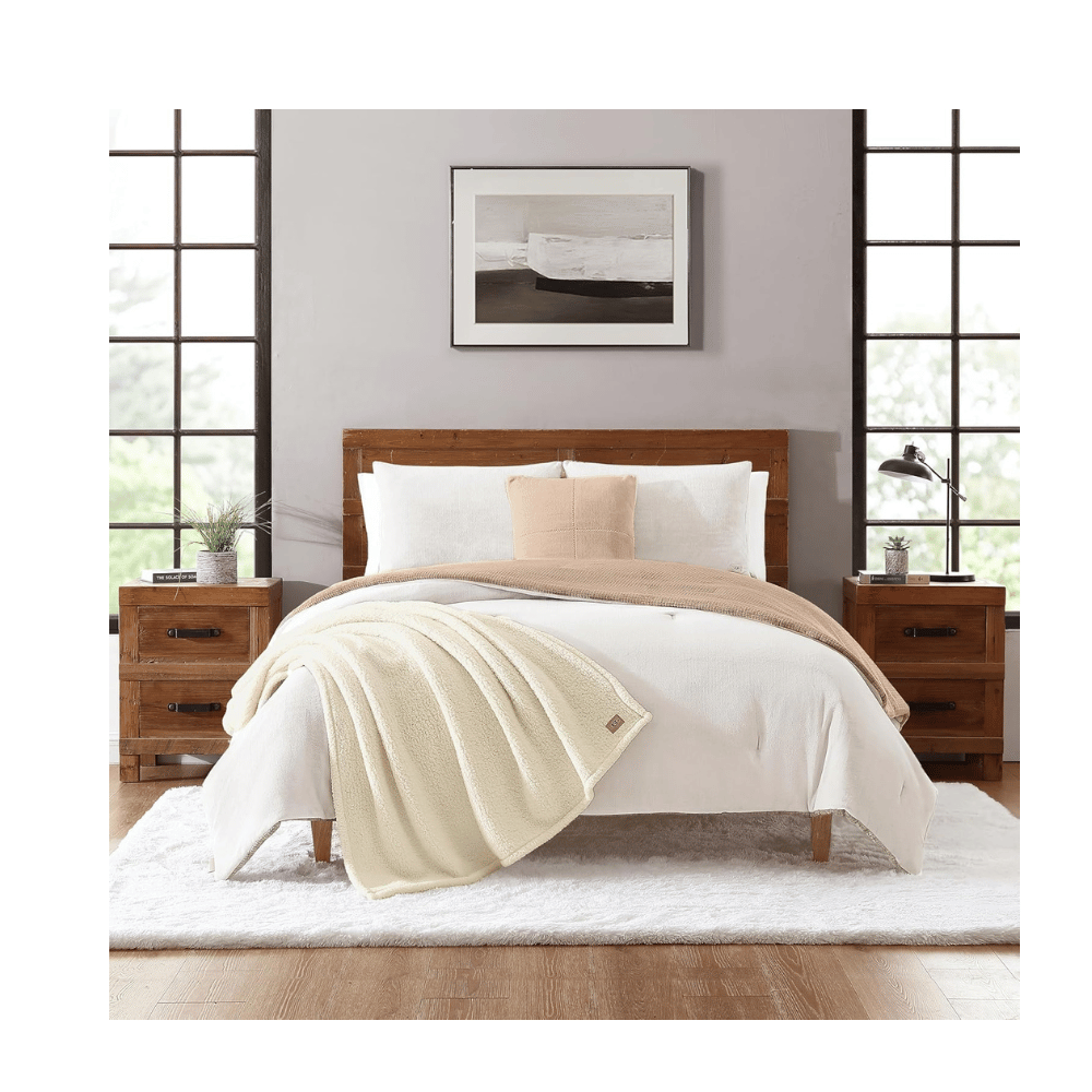 UGG Comforter Set styled on bed with wooden furniture (Credit: UGG / Amazon)