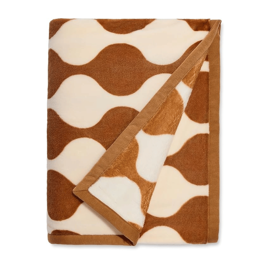 Folded tan and white patterned UGG Ariana Blanket with border trim (Credit: UGG / Amazon)