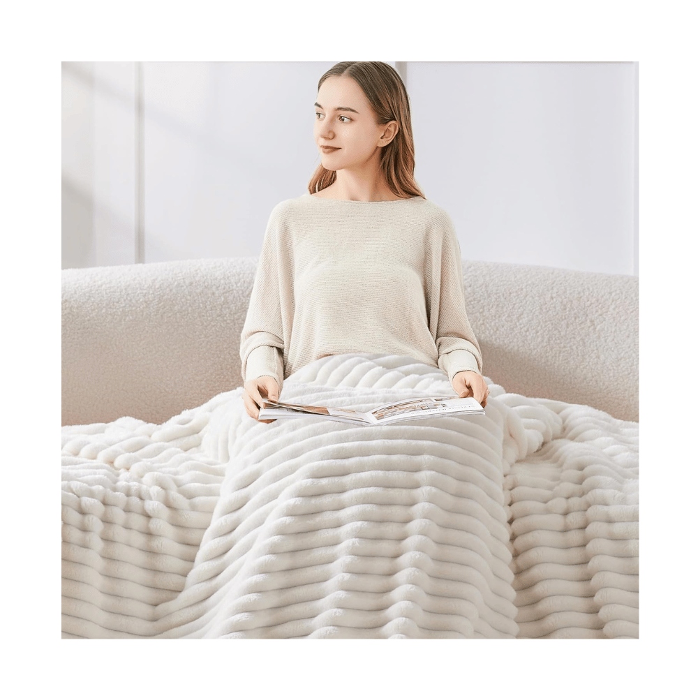 bedelite plush white blanket woman reading on sofa