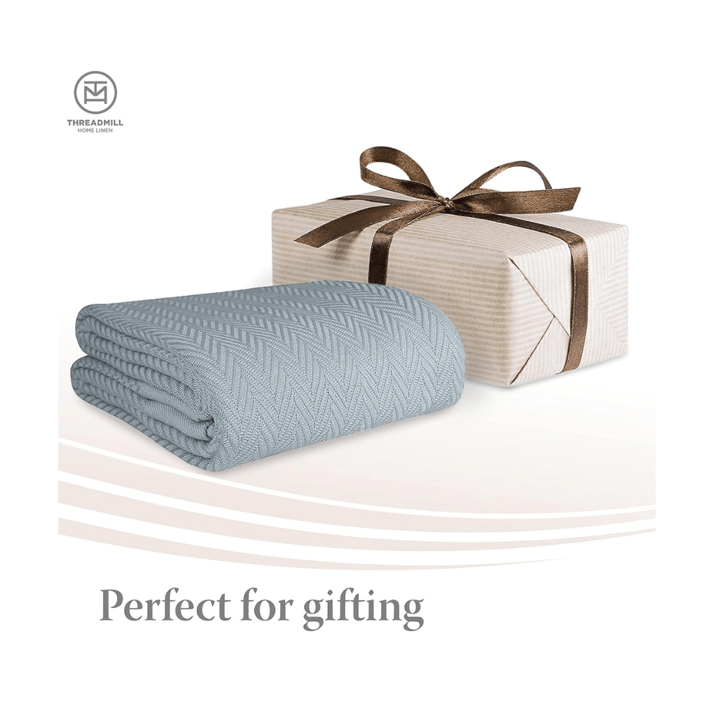 threadmill blue cotton blanket folded beside gift box
