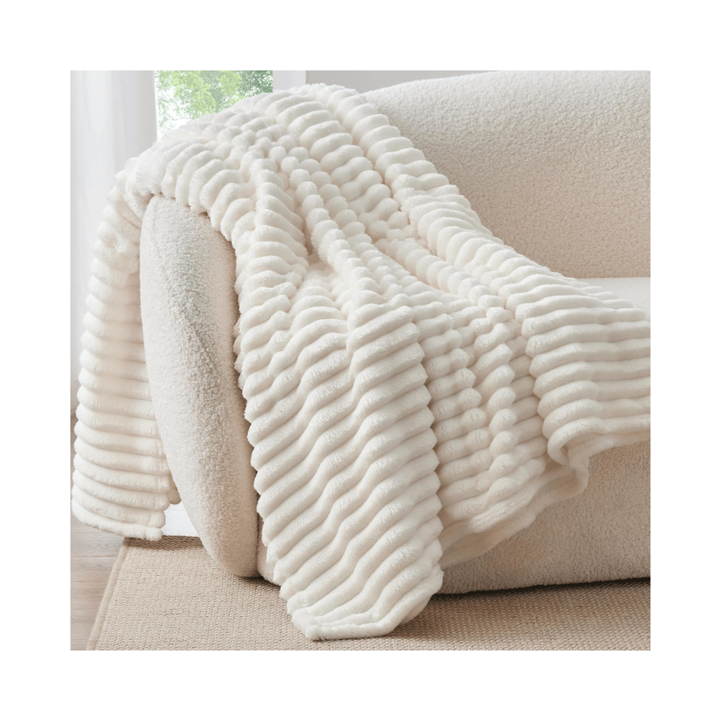 bedelite ribbed white blanket draped over cream sofa