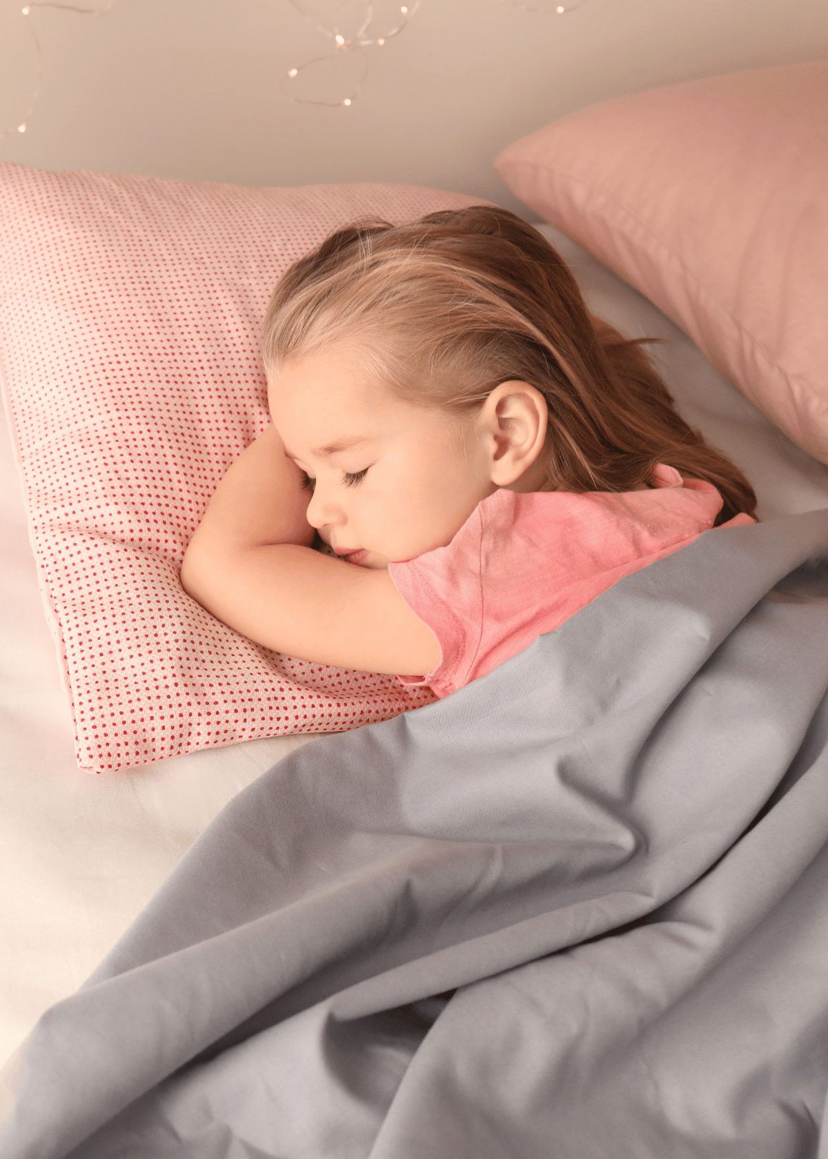 Alt tag: Peaceful toddler sleeping in bed (credit Canva)