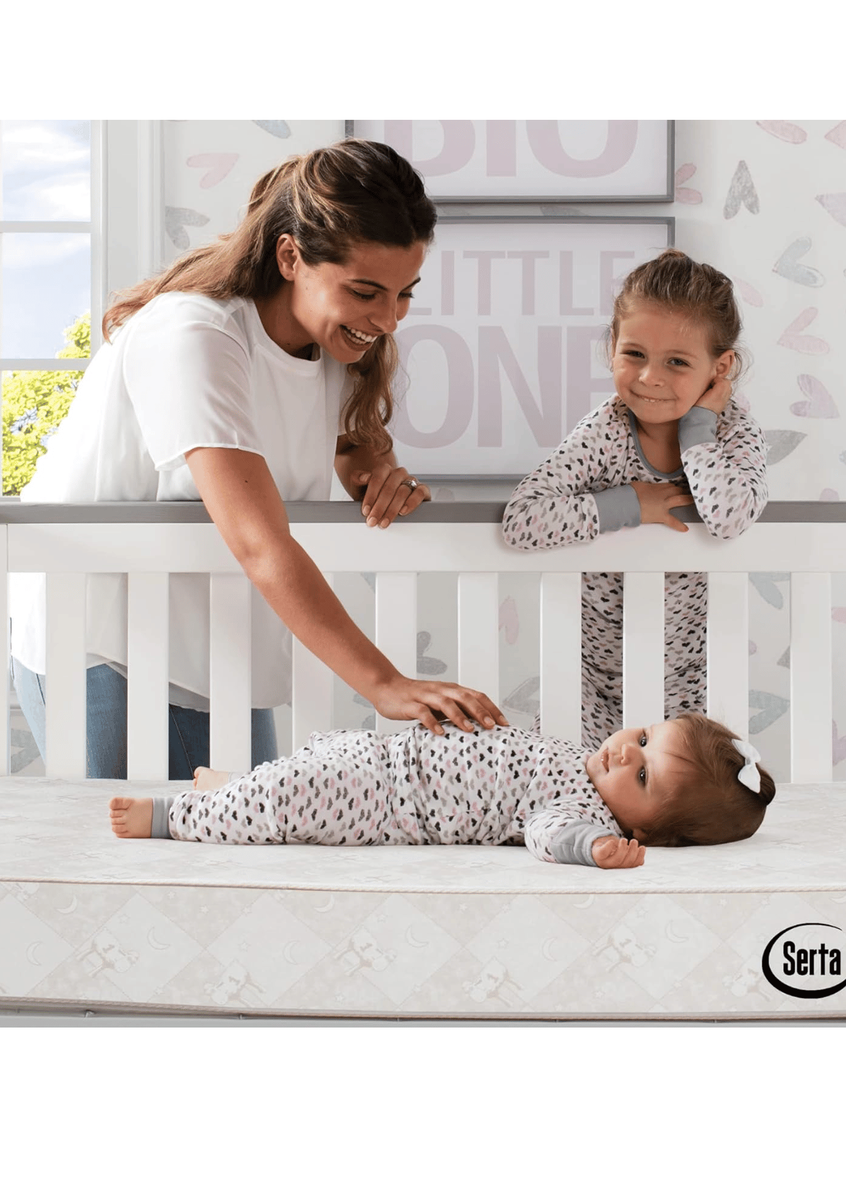 serta crib mattress with baby resting safely and mother comforting toddler